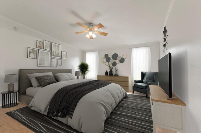 bedroom featuring wood-type flooring, ceiling fan, and ornamental molding