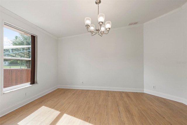 unfurnished room with crown molding, a chandelier, and light wood-type flooring