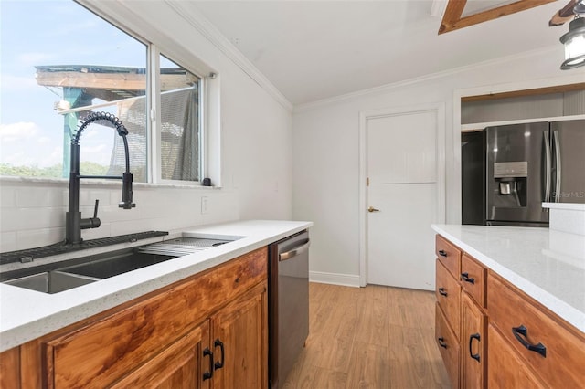 kitchen featuring backsplash, crown molding, sink, light wood-type flooring, and stainless steel appliances