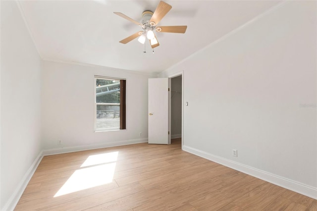 empty room with ceiling fan, light hardwood / wood-style floors, and ornamental molding