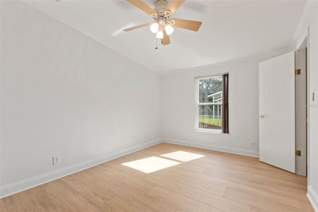 empty room with ceiling fan, light wood-type flooring, and ornamental molding