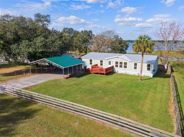 exterior space with a front lawn, a deck, and a carport