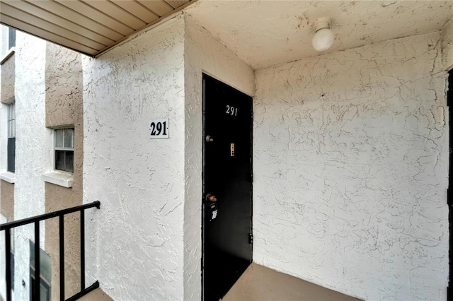 107 Caldwell Dr Unit 291, Brandon, FL 33510 - doorway to property featuring stucco siding and a balcony