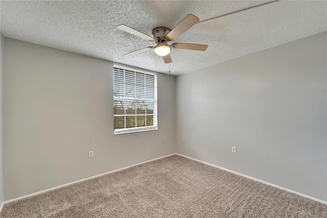 carpeted spare room with ceiling fan and a textured ceiling