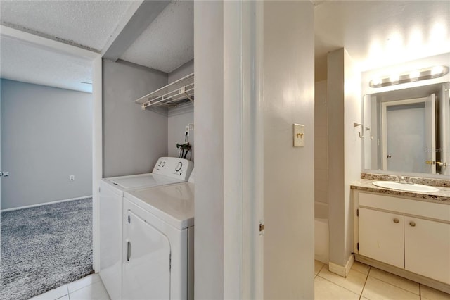 107 Caldwell Dr Unit 291, Brandon, FL 33510 - laundry area featuring washing machine and dryer, light tile patterned floors, baseboards, light colored carpet, and a textured ceiling