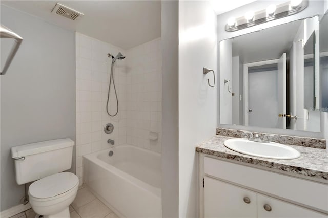 full bathroom featuring tile patterned floors, vanity, toilet, and tiled shower / bath