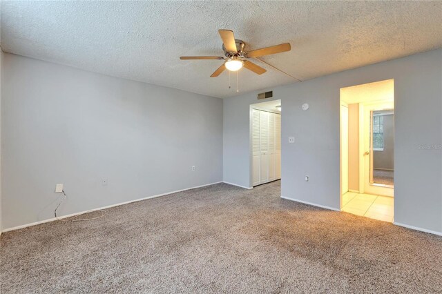 107 Caldwell Dr Unit 291, Brandon, FL 33510 - unfurnished bedroom featuring carpet, baseboards, a closet, a textured ceiling, and a ceiling fan