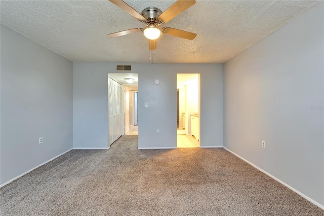 107 Caldwell Dr Unit 291, Brandon, FL 33510 - unfurnished bedroom with carpet, a textured ceiling, baseboards, ensuite bath, and ceiling fan