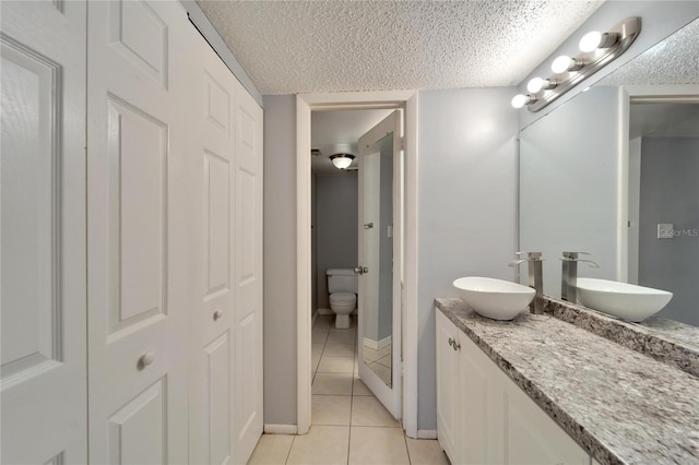 107 Caldwell Dr Unit 291, Brandon, FL 33510 - full bath with tile patterned flooring, double vanity, a closet, toilet, and a textured ceiling