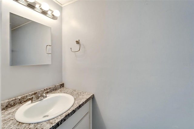 bathroom with vanity and ornamental molding