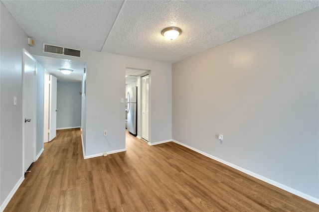 107 Caldwell Dr Unit 291, Brandon, FL 33510 - unfurnished room with a textured ceiling, wood finished floors, and baseboards