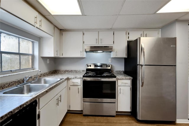 kitchen with stainless steel appliances, white cabinetry, and sink