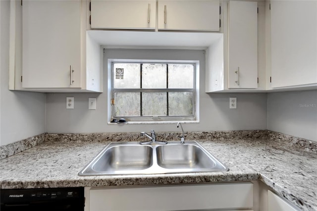 kitchen featuring dishwasher, white cabinetry, and sink