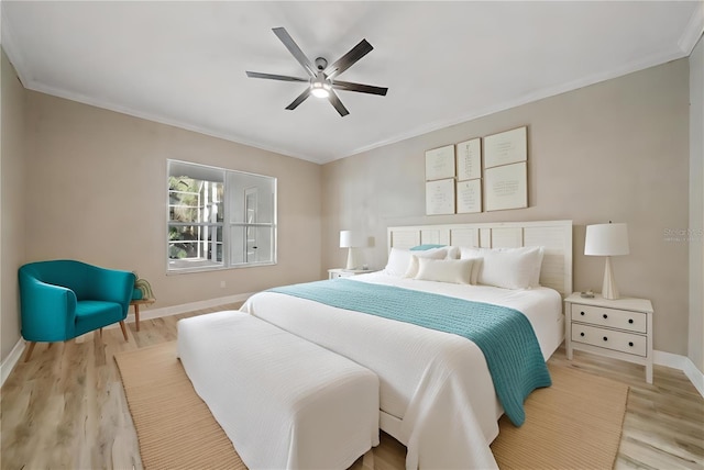 bedroom featuring light hardwood / wood-style flooring, ceiling fan, and crown molding