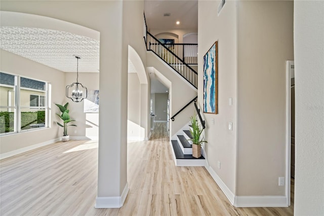 entrance foyer featuring a chandelier and light hardwood / wood-style floors