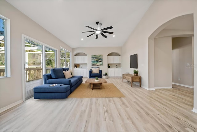 living room with light wood-type flooring, vaulted ceiling, and ceiling fan