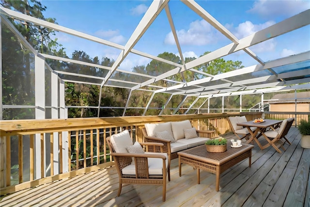 deck featuring an outdoor hangout area and glass enclosure