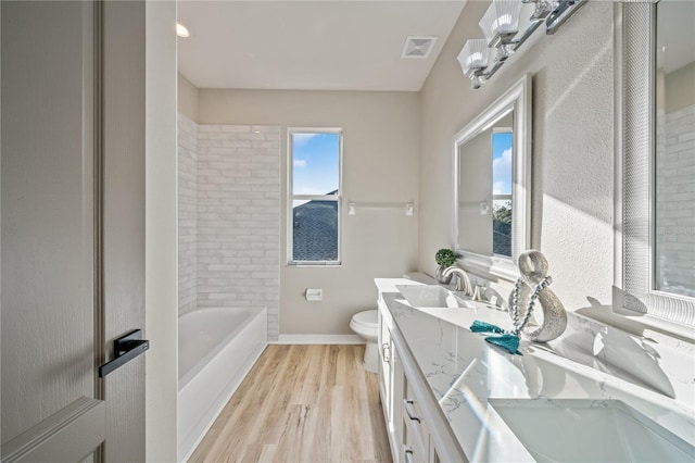 bathroom featuring wood-type flooring, vanity, and toilet