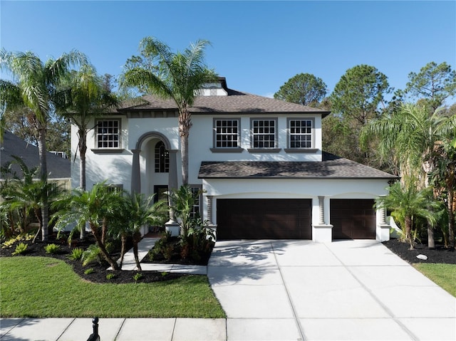 view of front of home featuring a garage and a front lawn