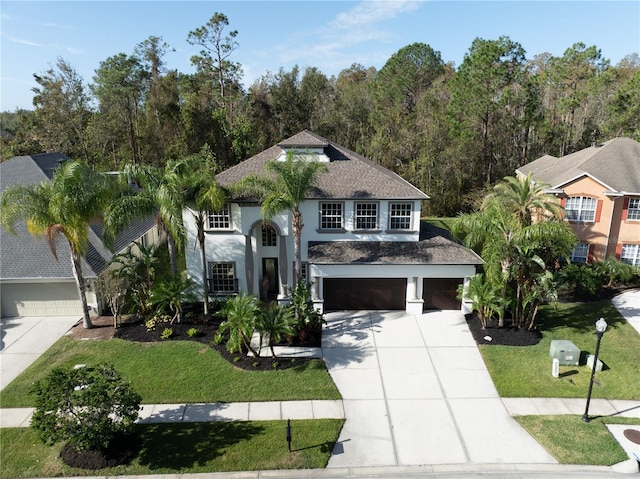 view of front facade featuring a garage and a front yard