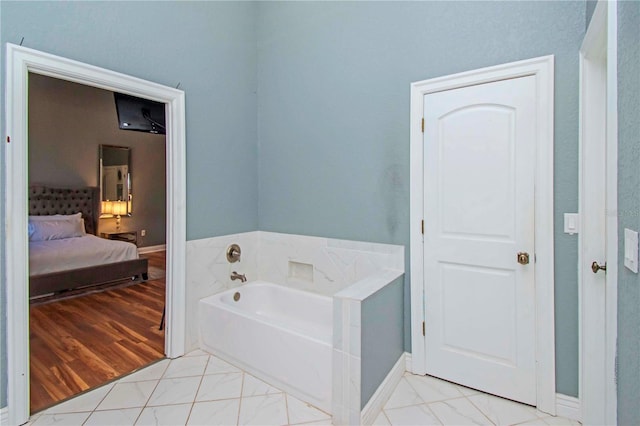 bathroom featuring tile patterned flooring and a tub