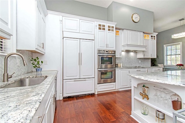 kitchen featuring white cabinetry, sink, stainless steel double oven, tasteful backsplash, and paneled built in fridge