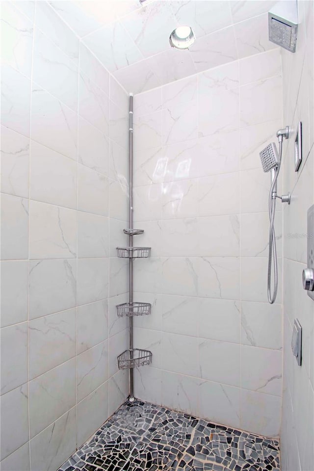 bathroom with a tile shower