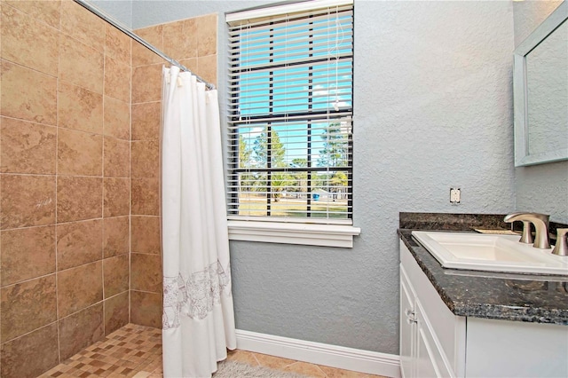 bathroom with curtained shower, tile patterned flooring, and vanity