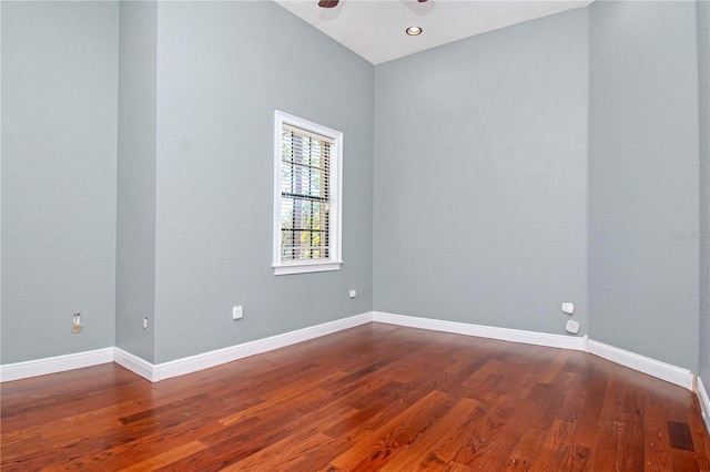 spare room with ceiling fan and wood-type flooring