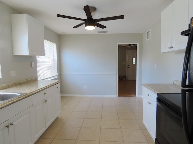 kitchen featuring black appliances, white cabinets, sink, ceiling fan, and light tile patterned flooring