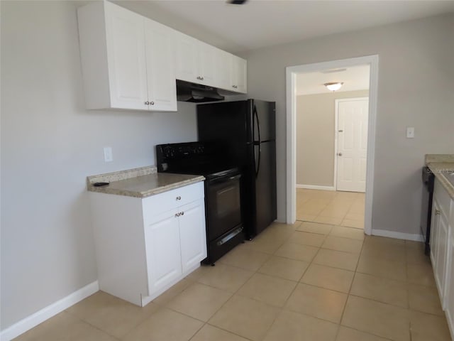 kitchen featuring electric range, white cabinets, dishwashing machine, and light tile patterned floors