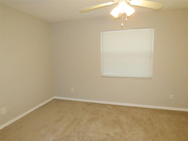 empty room featuring light colored carpet and ceiling fan