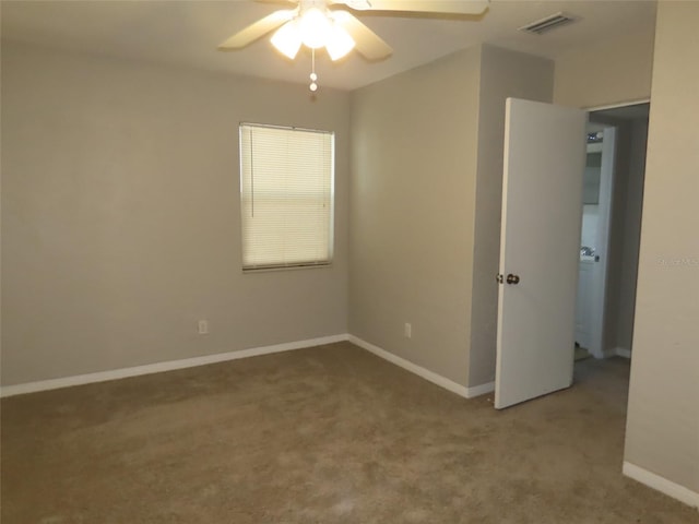 unfurnished room with ceiling fan and carpet floors