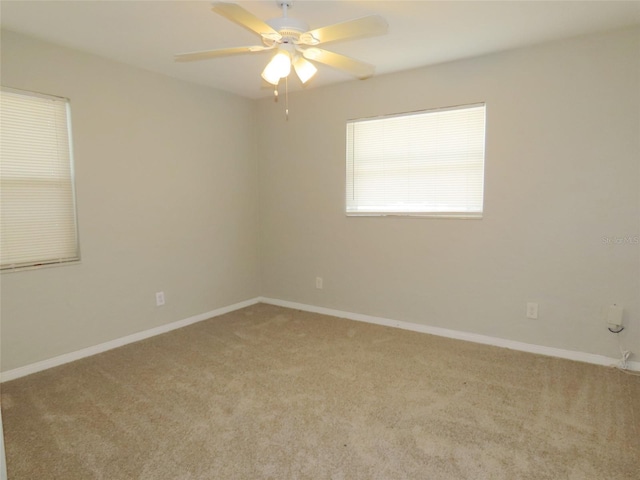 spare room with carpet and ceiling fan