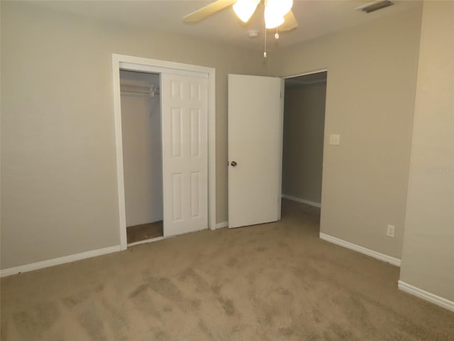 unfurnished bedroom featuring carpet, a closet, and ceiling fan