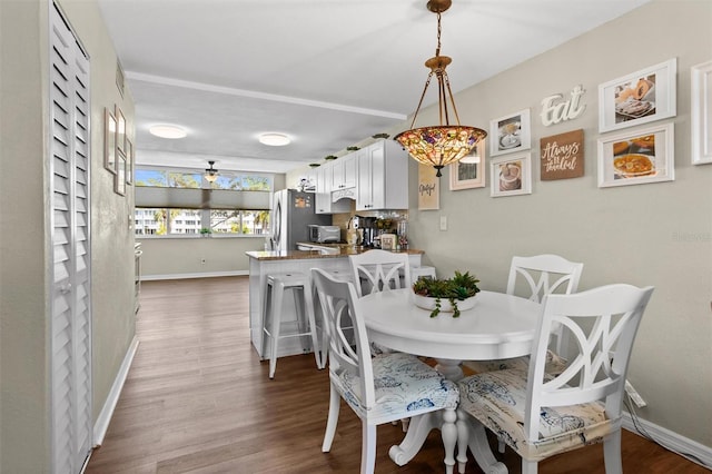 dining area featuring hardwood / wood-style flooring and ceiling fan