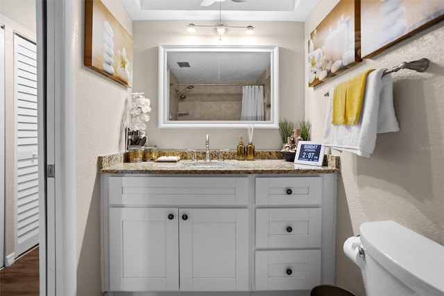 bathroom with a shower with shower curtain, vanity, toilet, and hardwood / wood-style floors