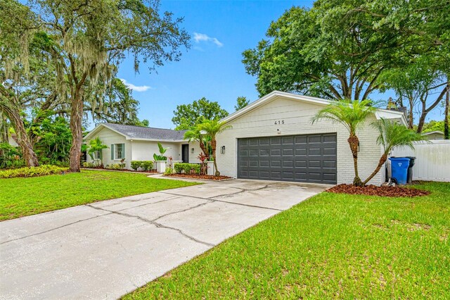 ranch-style house with a front yard and a garage