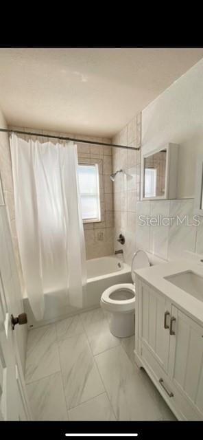 full bathroom with shower / bath combo with shower curtain, vanity, and toilet