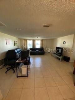 8906 Windsong Ln, Port Richey, FL 34668 - living area with a textured ceiling and light tile patterned floors