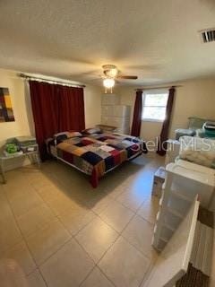 8906 Windsong Ln, Port Richey, FL 34668 - bedroom featuring ceiling fan and tile patterned flooring