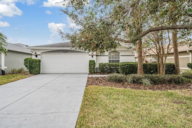 ranch-style home featuring a garage and a front lawn