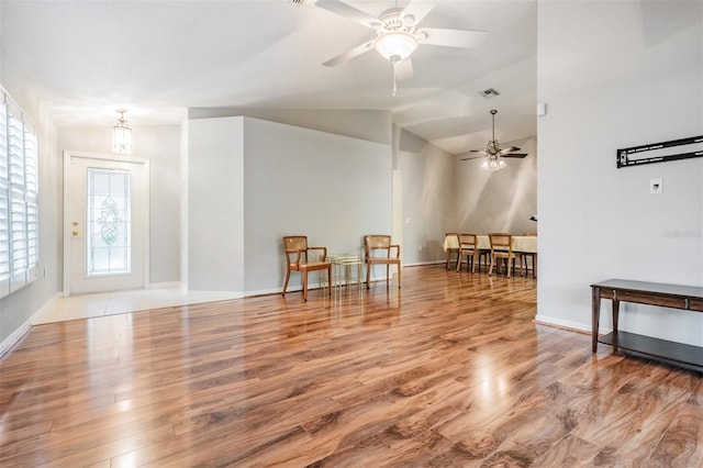 interior space with light wood-type flooring, ceiling fan, and lofted ceiling