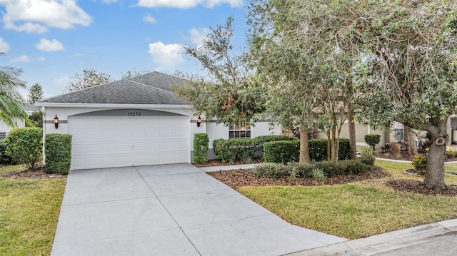 view of front of home with a front lawn and a garage