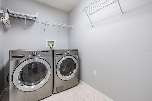 washroom with washing machine and dryer and light tile patterned floors