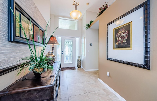 tiled foyer entrance featuring a high ceiling