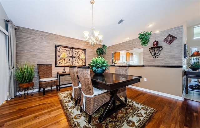 dining room featuring hardwood / wood-style flooring and a notable chandelier