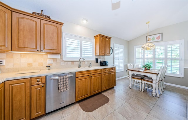 kitchen featuring pendant lighting, dishwasher, vaulted ceiling, decorative backsplash, and a notable chandelier