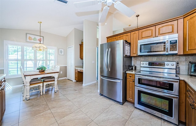 kitchen with ceiling fan, stainless steel appliances, tasteful backsplash, decorative light fixtures, and lofted ceiling