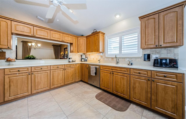 kitchen featuring backsplash, sink, stainless steel dishwasher, and a textured ceiling